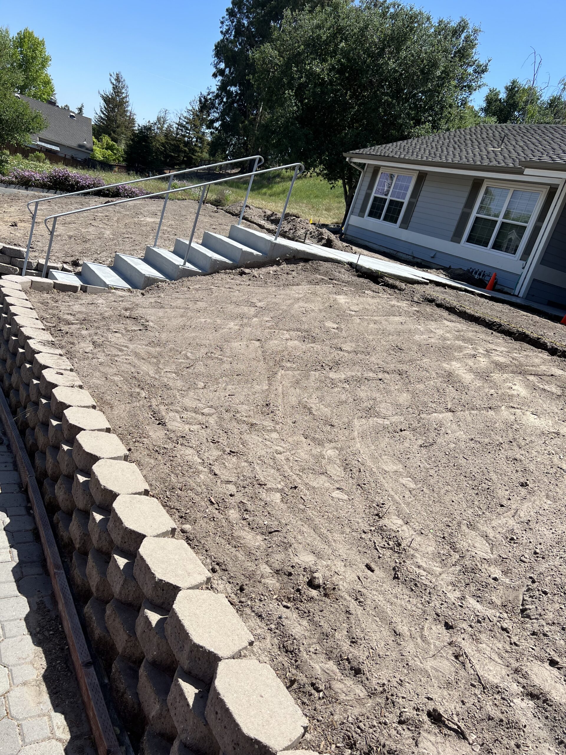 Retaining wall with fresh soil and sod prep