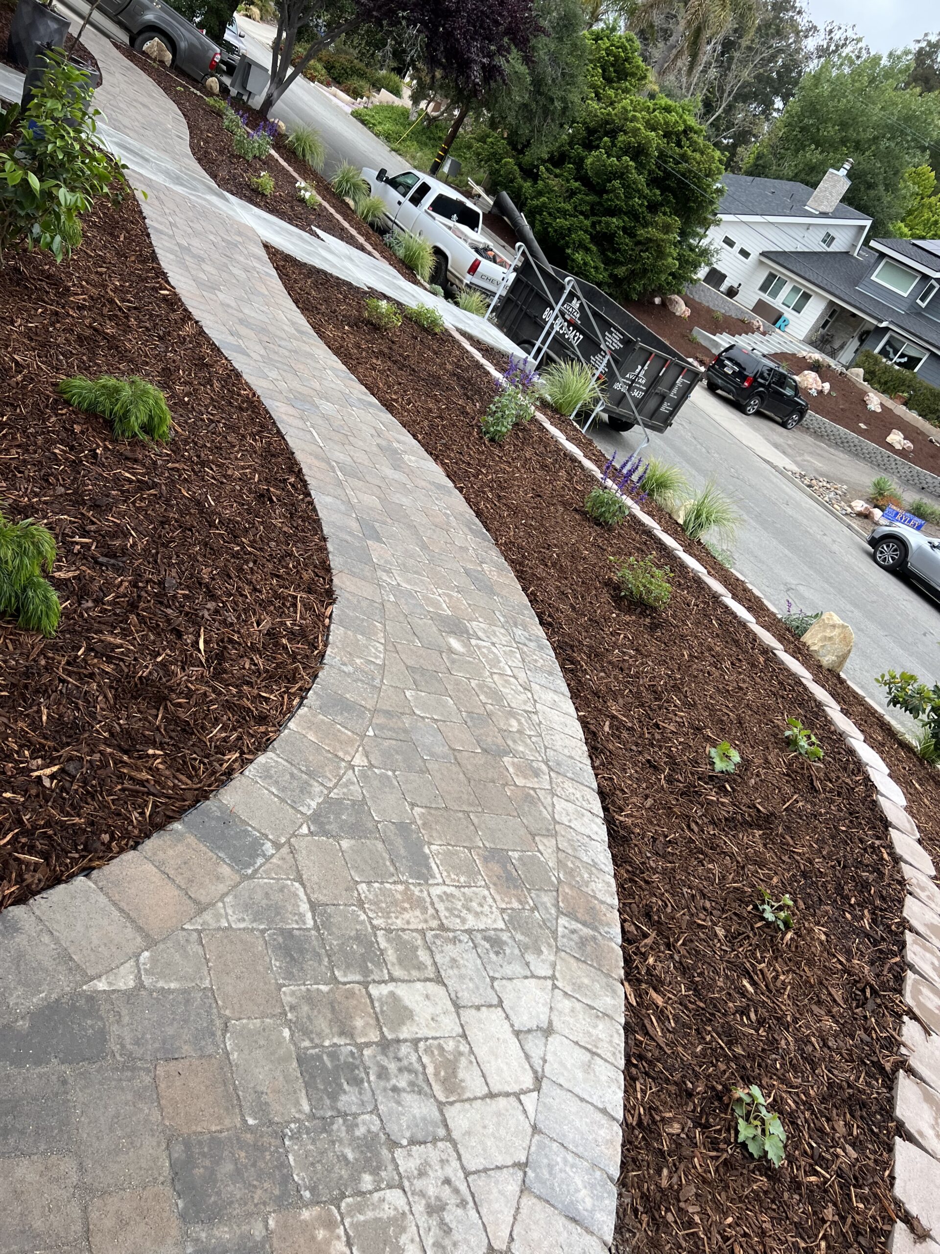 Curved paver walkway with mulch beds