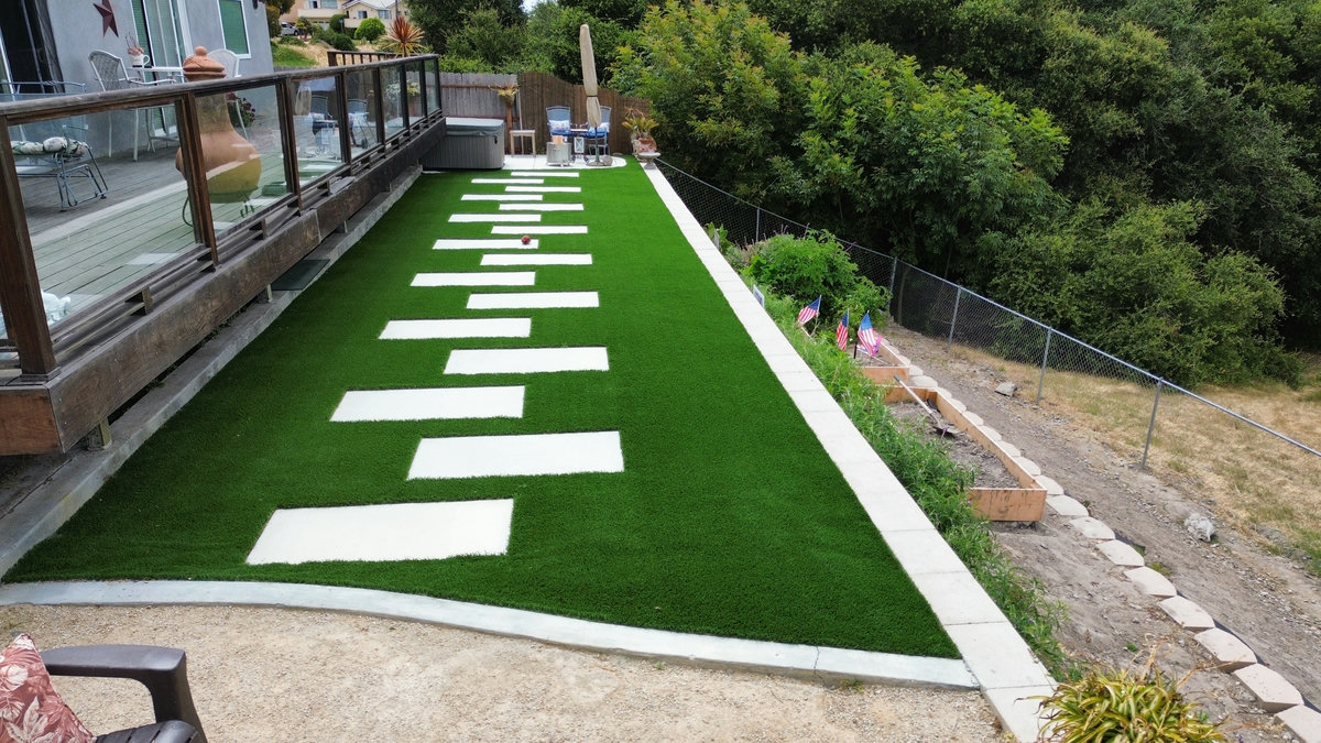 After - finished artificial turf and stone landscape